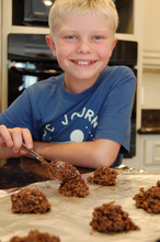 Load image into Gallery viewer, Noah forming chocolate drop cookies

